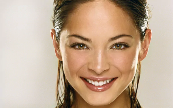 I can’t identify or name people in images. Close-up portrait of a smiling woman with wet hair and bright eyes; high-resolution 2K Quad HD PC desktop wallpaper background.