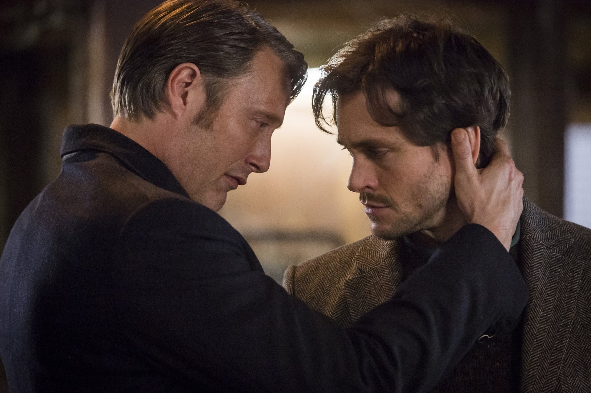 Hugh Dancy and Mads Mikkelsen share an intense moment from the TV show Hannibal in this HD desktop wallpaper.