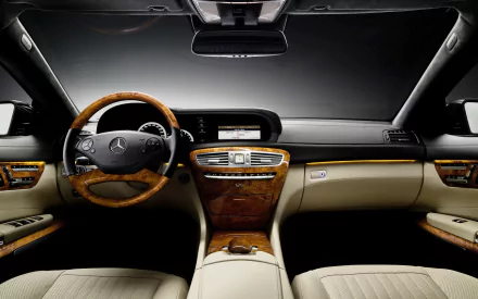 HD PC desktop wallpaper: luxury Mercedes-Benz CL-Class dashboard interior, wood-trim steering wheel, center console and beige leather seats.