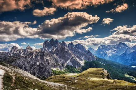 Stunning HD wallpaper featuring majestic mountains under a dramatic sky, showcasing the beauty of nature with rugged peaks and lush green valleys.