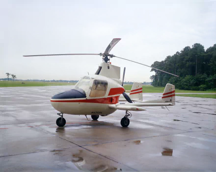 McCulloch J-2 Aero Super Gyroplane helicopter parked on wet tarmac under an overcast sky — NASA vehicle, HD PC desktop wallpaper/background.