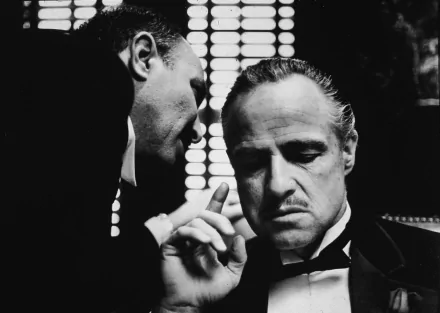 A striking black-and-white scene from The Godfather, featuring Marlon Brando in a classic pose, conveying intensity and authority. A cinematic tribute in 4K Ultra HD.