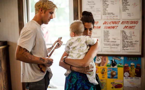 Luke and Romina from The Place Beyond The Pines hold their baby in a diner — 5K Ultra HD movie desktop wallpaper.