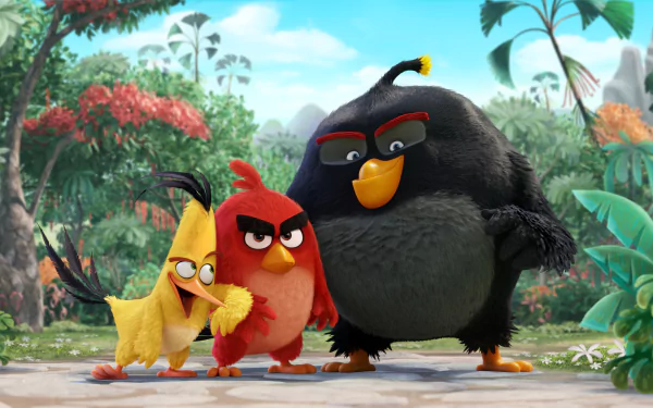 A vibrant HD desktop wallpaper featuring characters from The Angry Birds Movie. The scene showcases three colorful birds in a lush, tropical setting.