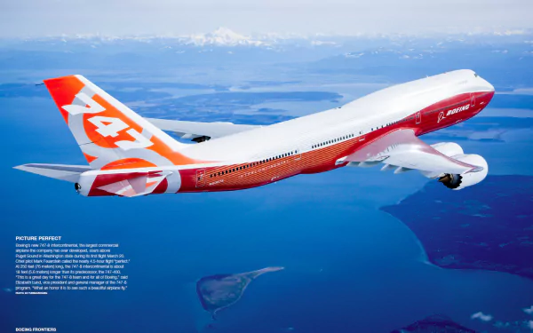 HD PC desktop wallpaper showing a Boeing 747-8 aircraft in flight over a large body of water with distant mountains in the background.