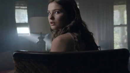 High-definition desktop wallpaper featuring Stefanie Scott from the movie Insidious: Chapter 3, capturing a tense moment as she looks back unexpectedly.