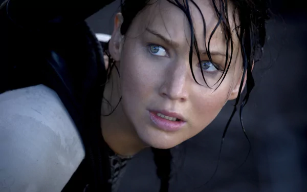 A striking image of Katniss Everdeen, portrayed by Jennifer Lawrence, capturing a tense moment from the movie The Hunger Games. A dynamic HD wallpaper for fans of the film.