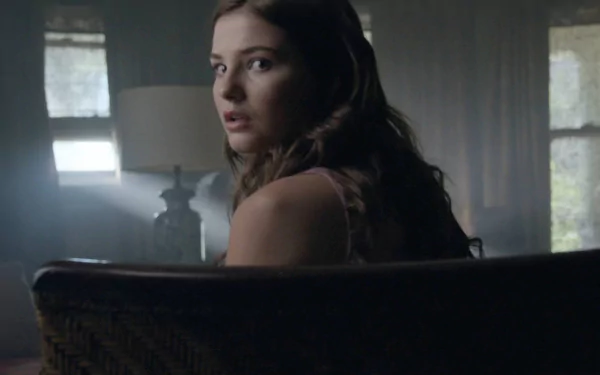 High-definition desktop wallpaper featuring Stefanie Scott from the movie Insidious: Chapter 3, capturing a tense moment as she looks back unexpectedly.