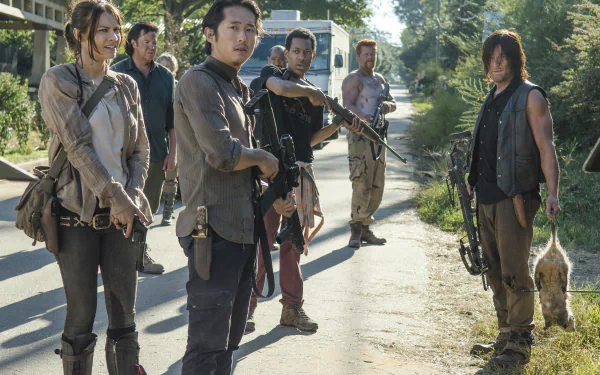 A dynamic scene from The Walking Dead featuring characters Abraham Ford, Daryl Dixon, Maggie Greene, and Glenn Rhee, showcasing their bold survival in a post-apocalyptic world.