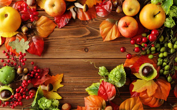 A vibrant still life featuring apples, berries, and colorful autumn leaves on a warm wooden background, capturing the essence of fall harvest. Perfect 4K Ultra HD wallpaper.