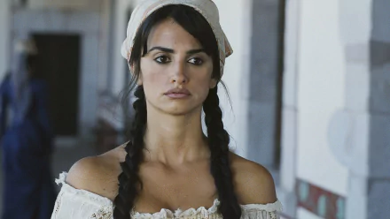 HD PC desktop wallpaper featuring Penelope Cruz in a scene from the movie Bandidas, showcasing her with braided hair and a white off-shoulder blouse.