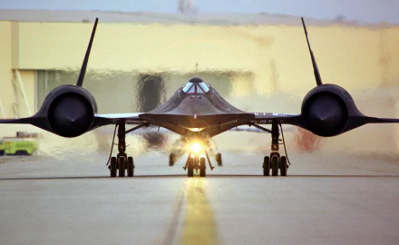 A striking HD wallpaper of the Lockheed SR-71 Blackbird, showcasing its sleek design as it prepares for takeoff on the runway, embodying military aviation prowess.