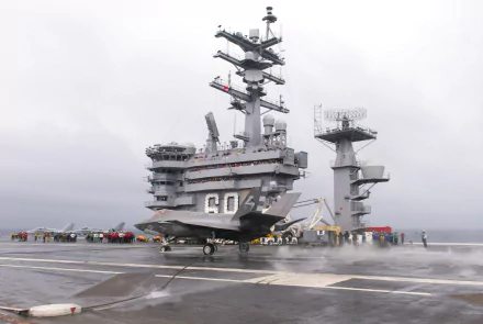 4K Ultra HD image of the USS Dwight D. Eisenhower (CVN-69) aircraft carrier with a jet on deck, showcasing military naval power and advanced warship design.