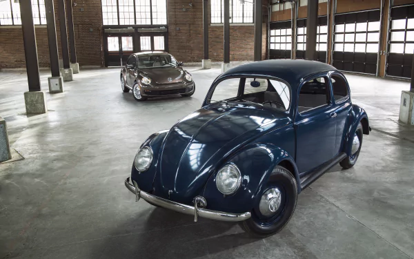 A 4K Ultra HD PC desktop wallpaper featuring two Volkswagen Beetle vehicles parked inside a spacious, industrial-style garage with large windows and exposed brick walls.