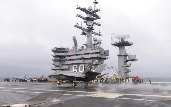 4K Ultra HD image of the USS Dwight D. Eisenhower (CVN-69) aircraft carrier with a jet on deck, showcasing military naval power and advanced warship design.