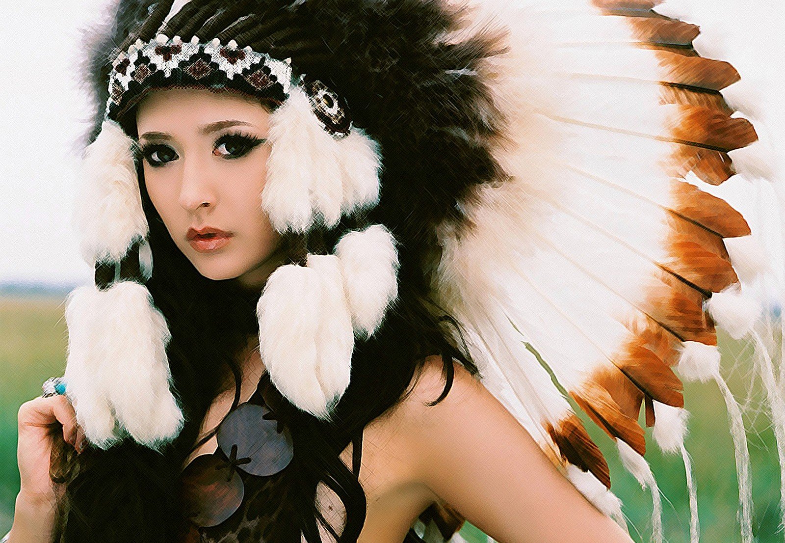 A striking HD desktop wallpaper featuring a Native American woman adorned with a traditional headdress, showcasing intricate details against a natural backdrop.