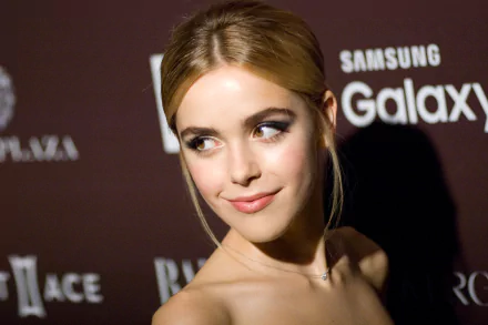 HD PC desktop wallpaper featuring celebrity Kiernan Shipka with a soft smile, elegant makeup, and an updo hairstyle against a dark event backdrop.