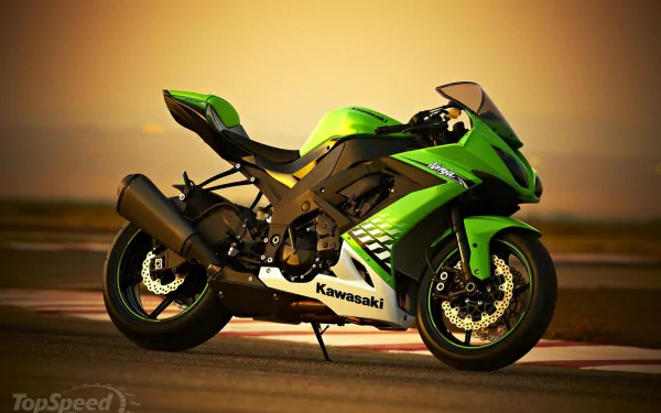 A high-definition wallpaper of a green Kawasaki Ninja motorcycle set against a warm sunset background.