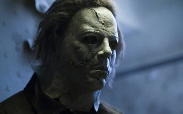 HD desktop wallpaper featuring Michael Myers from the movie Halloween II (2009), showcasing his iconic stitched mask in a dimly lit setting.