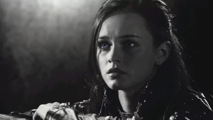 Close-up HD desktop wallpaper of Alexis Bledel in her role from the movie Sin City, featuring dramatic lighting and intense expression with striking blue eyes.