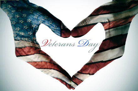 Hands painted with the American flag form a heart around Veterans Day script — 4K Ultra HD PC desktop wallpaper and holiday Veterans Day background.