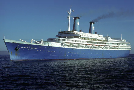 HD desktop wallpaper of the MS Achille Lauro, a large ocean liner cruise ship sailing on calm waters under a clear sky.