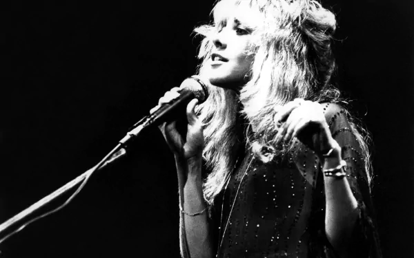 Black and white 4K Ultra HD desktop wallpaper featuring Stevie Nicks singing into a microphone, capturing a classic music moment.