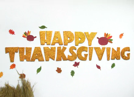 HD PC desktop wallpaper background: glittery HAPPY THANKSGIVING letters with two cartoon turkeys and scattered autumn leaves on a white background — holiday Thanksgiving design.