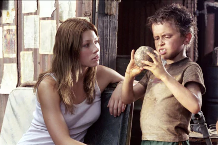 HD PC wallpaper: young woman and grimy boy examine a glass sphere in a tense scene from The Texas Chainsaw Massacre (2003).