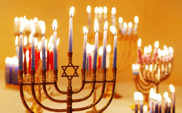 Brightly lit Hanukkah menorahs create a warm, festive glow in this 4K Ultra HD holiday desktop wallpaper.