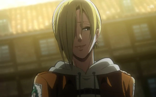 Annie Leonhart from Attack on Titan smiles softly in this HD anime wallpaper, capturing her enigmatic character against a warm background.