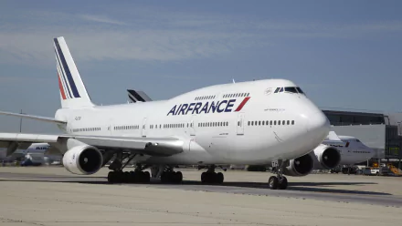 A Boeing 747 passenger plane, branded with Air France livery, is seen on the tarmac, showcasing its impressive design and stature in this high-definition desktop wallpaper.