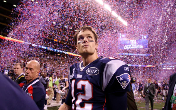 4K Ultra HD desktop wallpaper featuring a New England Patriots player on the field amid celebratory confetti during a sports event.
