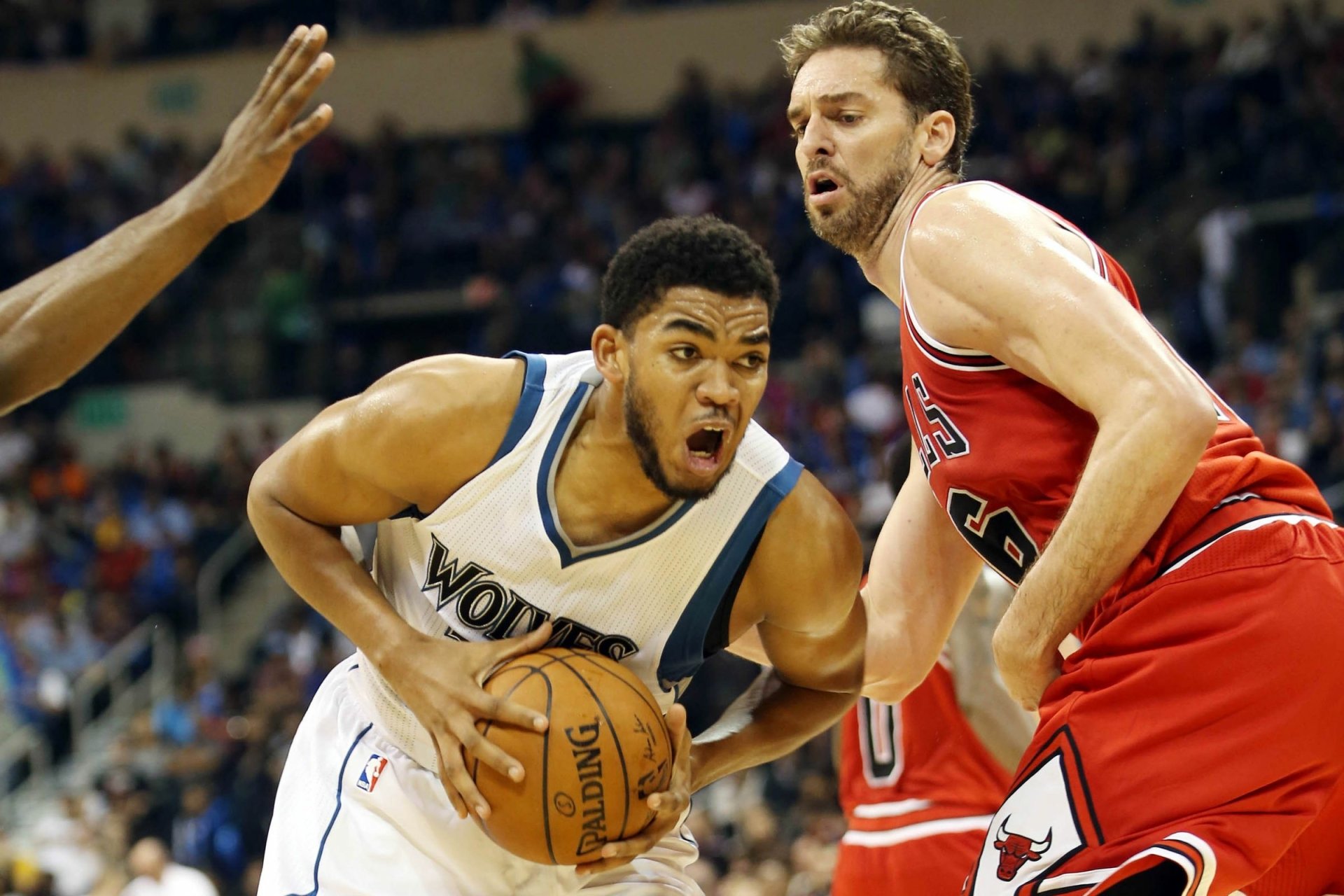 HD PC desktop wallpaper background — basketball sports action: a Timberwolves player powers to the basket as a Bulls defender tries to stop him in a packed arena.