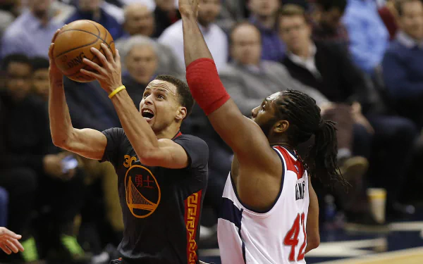 Stephen Curry of the Golden State Warriors takes a shot while being defended by an opponent in a high-energy basketball moment. HD wallpaper showcasing sports action.