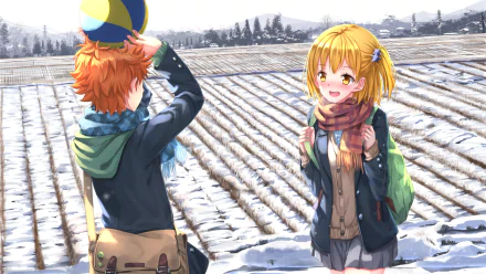A HD desktop wallpaper featuring Shōyō Hinata and Hitoka Yachi from the anime Haikyū!!. They are outdoors, with Hinata holding a volleyball and both characters bundled up in winter clothing.