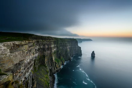 A stunning seascape of the Cliffs of Moher in Ireland, showcasing dramatic cliffs rising from the sea against a twilight sky, captured in vibrant 4K Ultra HD.