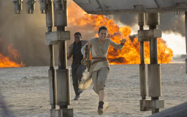 Rey and Finn sprint away from an explosion in this dynamic scene from Star Wars Episode VII: The Force Awakens, showcasing the thrill of adventure in the galaxy far, far away.