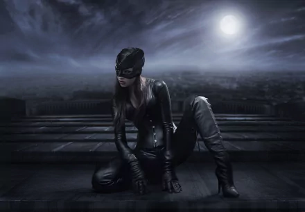 HD desktop wallpaper of a woman in Catwoman cosplay from DC Comics, kneeling in a dark, moonlit cityscape.
