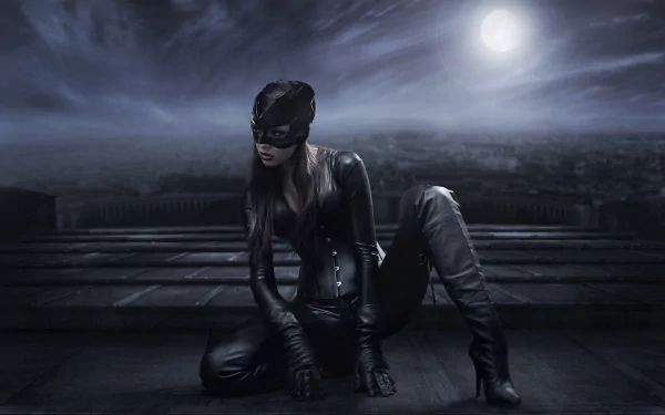 HD desktop wallpaper of a woman in Catwoman cosplay from DC Comics, kneeling in a dark, moonlit cityscape.