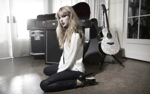 HD desktop wallpaper featuring Taylor Swift, stylishly posed with a sparkling guitar and musical equipment in a bright, modern setting.