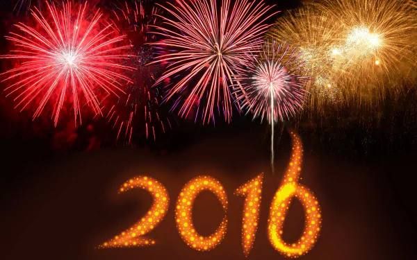 Vibrant fireworks burst over a glowing 2016 in a dark sky — New Year holiday scene, 2K Quad HD PC desktop wallpaper and background.