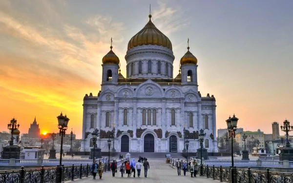 The Cathedral of Christ the Saviour in Moscow, Russia, stands majestically at sunset, showcasing its iconic golden domes and intricate architecture against the city skyline.