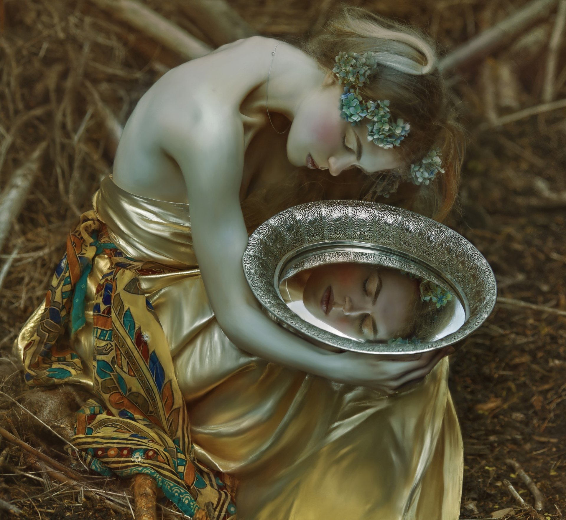 HD PC desktop wallpaper of a moody woman in a golden dress cradling a reflective bowl showing her mirrored face, floral hair accents and muted, introspective tones.