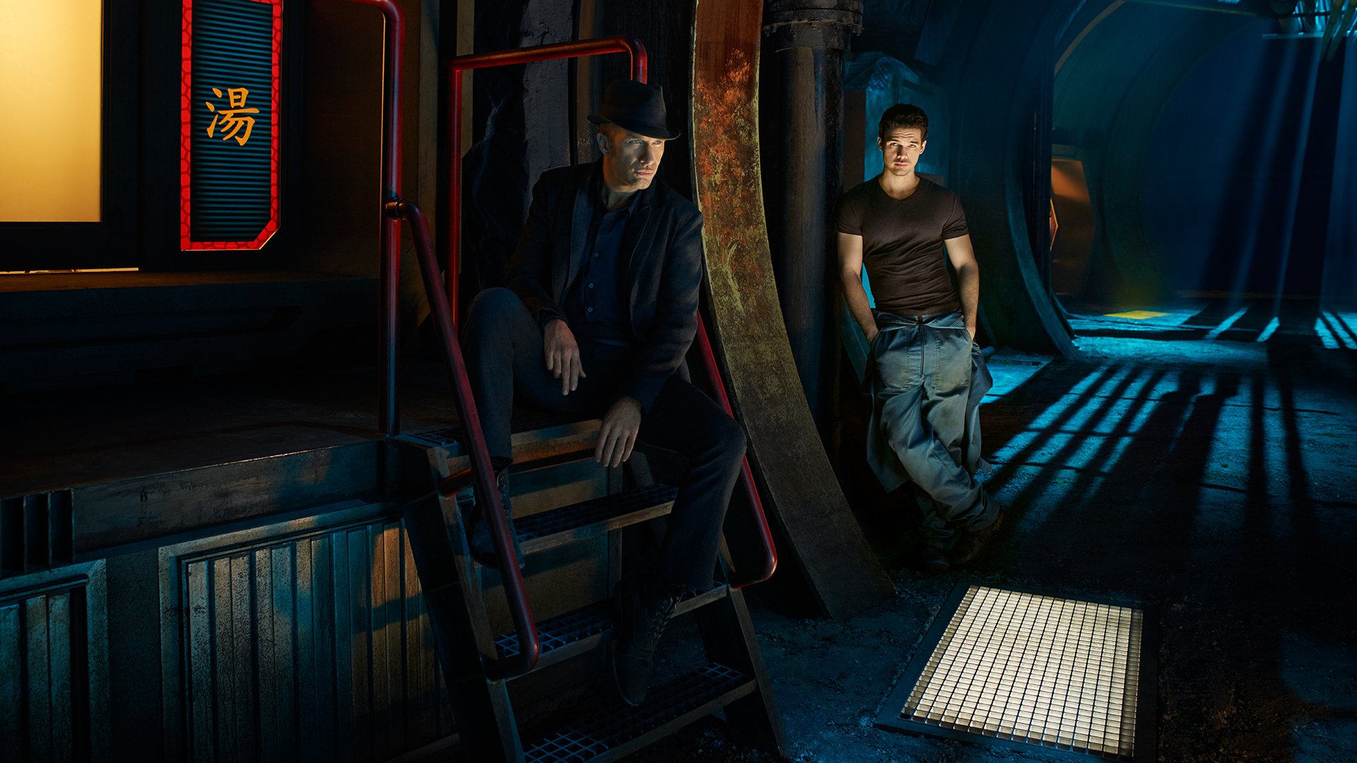 HD desktop wallpaper from TV series The Expanse: James Holden stands in a blue-lit ship corridor while a crewmate sits on metal steps amid dramatic shadows.
