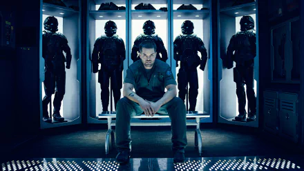 HD PC desktop wallpaper featuring Wes Chatham as Amos Burton from the TV show The Expanse, seated in a futuristic armory with armored suits behind him.