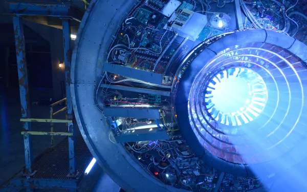 HD PC desktop wallpaper featuring a futuristic circular machine emitting bright blue light, inspired by the TV show 12 Monkeys.