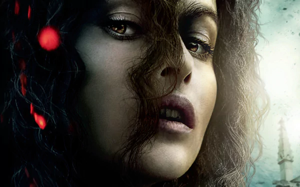 Close-up of Bellatrix Lestrange with dark curls and intense eyes from Harry Potter and the Deathly Hallows: Part 2, featured as an HD PC desktop wallpaper.