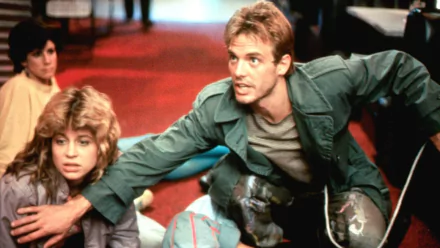 A dynamic scene from the movie The Terminator, showcasing characters in a tense moment, set against a striking red carpet backdrop. HD PC desktop wallpaper.