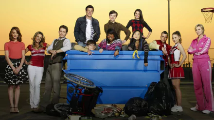 HD PC desktop wallpaper for TV show Glee: a diverse group posed around a blue dumpster against a bright yellow backdrop.